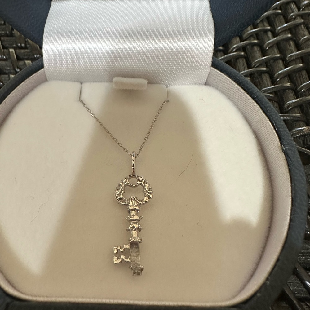 14K white gold 18” Chain and “key” charm. New in box. Brick’s Jewelers. Pretty!